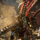 A person with the PSVR2 headset and controllers is in the bottom right corner of the screen while the main image is of a giant robot dinosaur charging at the screen.